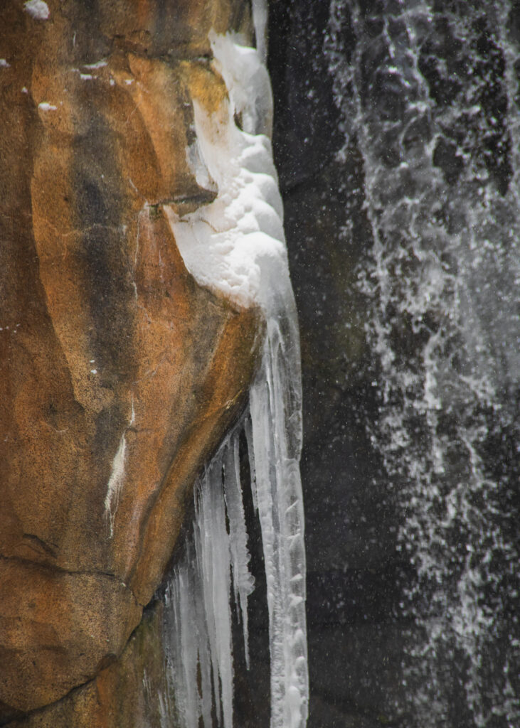 Wall of rock dripping icicles next to the waterfall in the polar bear enclosure in Chicago. test post